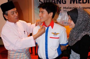 Captain James Anthony Tan (centre) receives his wings before take-off from Langkawi, Malaysia.