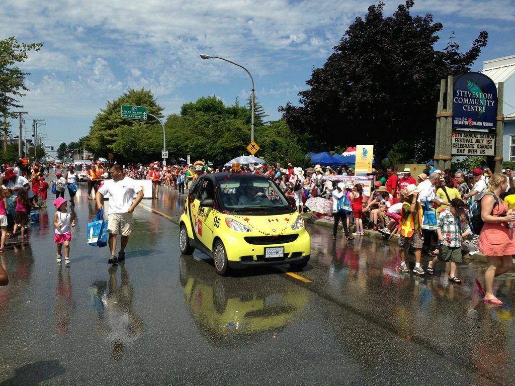 The YVR SmartCar cruises down Mocton Street in Steveston during the 2013 Canada Day Steveston Salmon Festival.