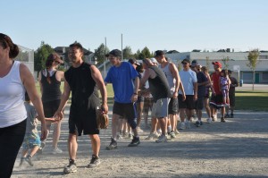 Teams greet each other at King George Park, Richmond at the start of the annual Rubina Hope for Kids Softball Slam fundraising event.