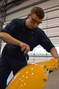 Cadet Ben Stipkala of 676  Kittyhawk Squadron, Sidney, B.C. installs an engine cowling air filter in a C182 tow plane.